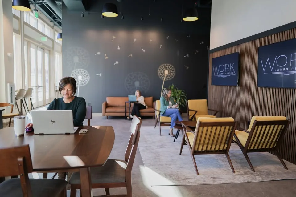 Guests working inside WORK Lakes Region coworking space in Laconia