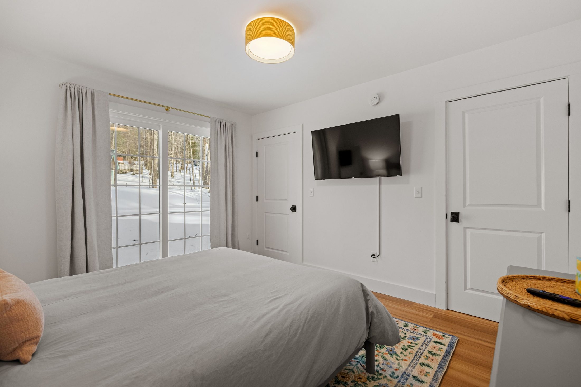 Primary bedroom with a queen bed and sliding glass door to the yard