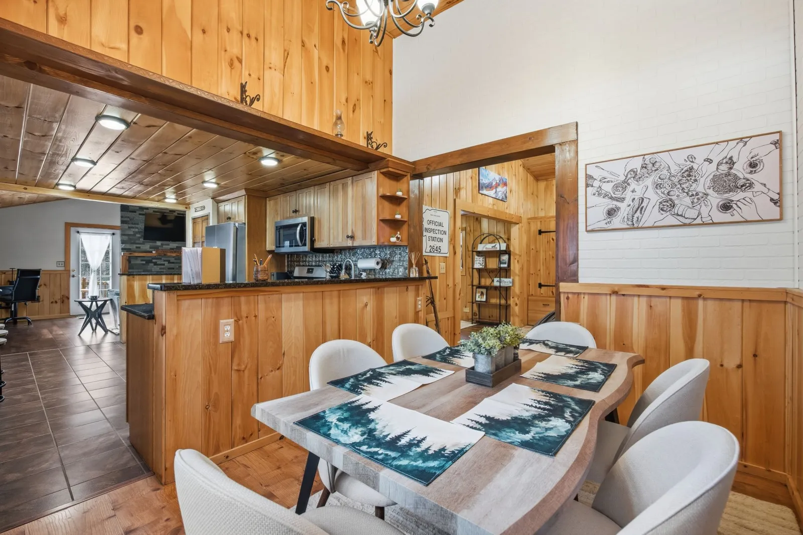 Live-edge wood dining table seating six, with a kitchen visible beyond